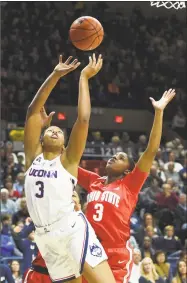  ?? Stephen Dunn / Associated Press ?? UConn’s Megan Walker, left, and Ohio State’s Janai Crooms fight for a rebound in the first half on Sunday.