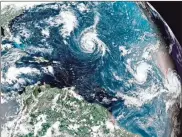  ??  ?? This enhanced satellite image made available by NOAA shows Tropical Storm Florence, center, in the Atlantic Ocean on Saturday. / NOAA