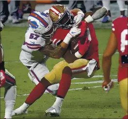  ?? ROSS D. FRANKLIN — THE ASSOCIATED PRESS ?? 49ers running back Jeff Wilson gets dragged down by Bills defensive end A.J. Epenesa in the second half Monday at State Farm Stadium in Glendale, Ariz.