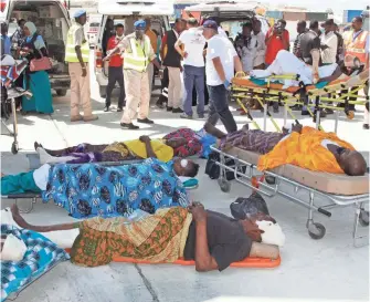  ?? FARAH ABDI WARSAMEH, AP ?? Some of the most critically wounded survivors of the weekend attack in Mogadishu, Somalia, wait to be taken by air ambulance to Turkey on Monday for treatment.