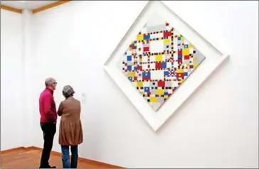  ?? SELINA KOK FOR THE WASHINGTON POST ?? Visitors view Piet Mondrian’s at Gemeentemu­seum Den Haag in The Hague. The painting is considered one of the most important works of 20th-century art and is in the museum’s permanent collection.