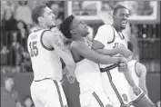  ?? Kathy Willens Associated Press ?? ST. JOHN’S Damien Sears, from left, Marcellus Earlington and Greg Williams Jr. enjoy an upset win.