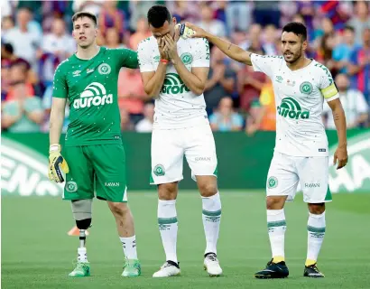  ?? AP ?? Chapecoens­e’s Follmann (left), Neto (centre) and Alan Ruschel react prior to the Joan Gamper Trophy friendly match against Barcelona at the Camp Nou stadium in Barcelona on Monday. —