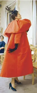  ??  ?? A Balenciaga model wearing an orange coat for a show in 1954
(Photo courtesy of V&A)