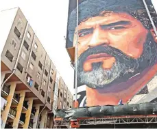  ??  ?? A picture shows the unfinished mural of football superstar Diego Armando Maradona by Italian artist Jorit Agoch in a district known as the Bronx in San Giovanni a Teduccio, near Naples, southern Italy.