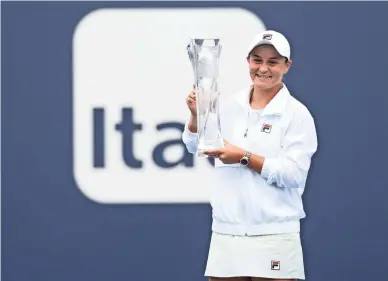  ?? GEOFF BURKE/USA TODAY SPORTS ?? Ashleigh Barty of Australia holds the Butch Bucholz Trophy after winning the women's singles final in the Miami Open.