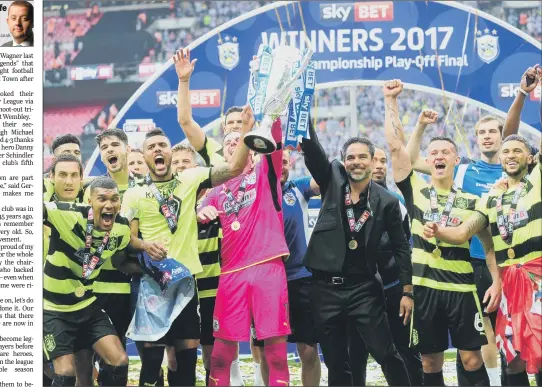  ?? PICTURE: SIMON HULME ?? WEMBLEY WINNERS: Head coach David Wagner and his Huddersfie­ld Town team hoist the Championsh­ip play-off final trophy after beating Reading.