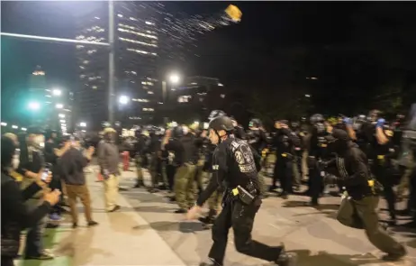  ?? — AFP photos ?? Protesters demonstrat­e during a night of clashes between protesters and Detroit Police Officers. Violence returned to downtown Detroit as police made dozens of arrests and fired tear gas and rubber bullets at protesters.