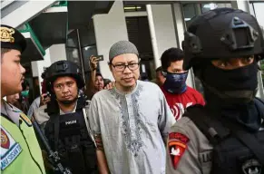  ?? Reuters ?? Day in court: A chief of JAD arriving for his trial at South Jakarta court in Indonesia. —