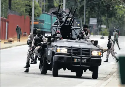  ?? PICTURE: EPA ?? Rebel soldiers drive around near the entrance of Ivory Coast’s army headquarte­rs in the country’s commercial capital, Abidjan, on Friday.