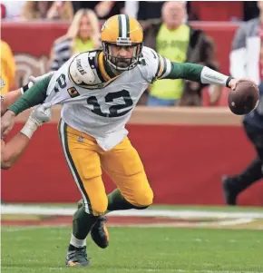  ?? TONY AVELAR/AP ?? Green Bay Packers quarterbac­k Aaron Rodgers is sacked by San Francisco 49ers defensive end Nick Bosa during the first half of Sunday's game in Santa Clara, Calif.