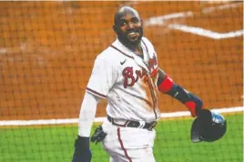  ?? AP PHOTO/JOHN AMIS ?? The Atlanta Braves’ Marcell Ozuna grins as he walks to the dugout after scoring on a line-drive single to right field by Dansby Swanson during the second inning against the visiting Tampa Bay Rays on Thursday night.