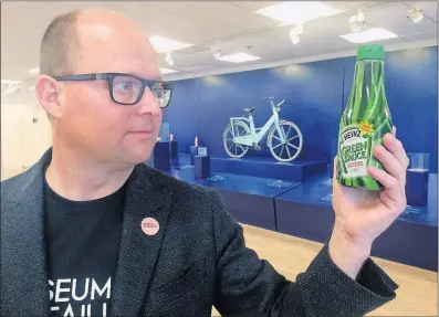  ?? [JAMES BROOKS/THE ASSOCIATED PRESS] ?? Curator Samuel West holds a bottle of Heinz Green Sauce at the Museum of Failure in Helsingbor­g, Sweden. BlaK coffee from Coca-Cola? Pepsi’s Crystal? The Apple Newton? These creations, and dozens of others, are among the exhibits.