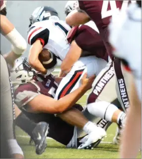  ??  ?? Senior Carson Rhine is brought down by multiple Siloam Springs Panthers Friday night.