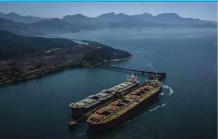  ?? BLOOMBERG PIC ?? A machine loading iron ore into bulk carrier vessels at the Vale S.A. Guaiba Island Terminal in Rio de Janeiro. Vale says its first blockchain transactio­n for iron ore is a big step towards the digitalisa­tion of the sales and trade finance process in the steel value chain.