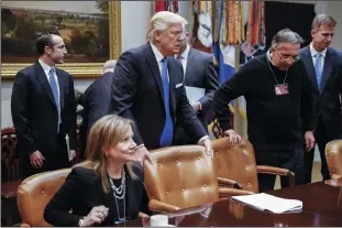  ?? SIPA USA FILE PHOTOGRAPH ?? President Donald Trump, center, with CEO of General Motors Mary Barra, left, and CEO of Fiat Chrysler Automobile­s Sergio Marchionne, second from right, takes his seat prior to delivering remarks to automobile industry leaders on Jan. 24, 2017, in the Roosevelt Room of the White House in Washington, D.C.