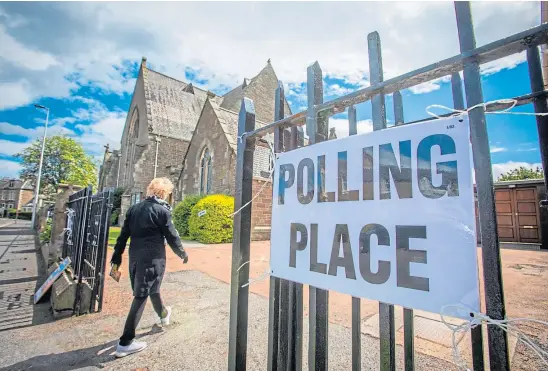  ??  ?? DECISION DAY: A voter strides with purpose to a polling station on Queen Street, Broughty Ferry, during elections in May 2019.