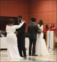  ?? Haley Smith/News-Times ?? Dancing the night away: Debutantes dancing the traditiona­l waltz with their Escorts on Saturday. From Left to right: Elsie Lyle, Fredrick Jackson III, Ramon Jackson and Chelsey Brown.