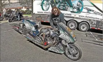  ?? PHOTOS BY CHRIS BARBER — DIGITAL FIRST MEDIA ?? Rich Vreeland shows off his Harley-Davidson racing bike that runs on nitrometha­ne, at the annual Blessing of the Bikes ceremony on Sunday at the Power Place Church in Kennett Township.