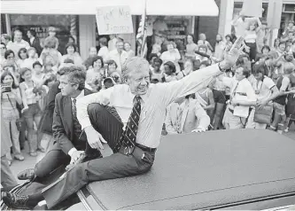  ?? Associated Press file photo ?? President Jimmy Carter waves from the roof of his car in a parade through Bardstown, Ky., on July 31, 1979. He was 56 when he left office and spent the rest of his life in service to others.