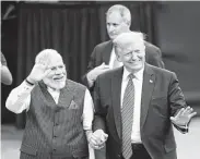  ?? Steve Gonzales / Staff photograph­er ?? Indian Prime Minister Narendra Modi and President Donald Trump walk hand in hand.