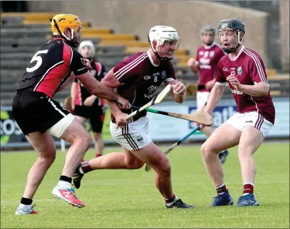  ??  ?? Aaron Maddock of St. Martin’s has support from David Codd as he tries to break away from Eoin Moore (Oulart-The Ballagh).