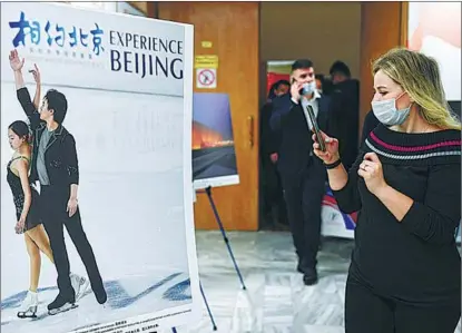  ?? XINHUA ?? Visitors attend a photo exhibition in Moscow promoting the Beijing Winter Olympics on Jan 21. Russia will send more than 500 people to the Games.