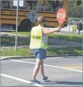  ?? PETE BANNAN - MEDIANEWS GROUP ?? A crossing guard stops traffic in front of Holy Cross Elementary School in Springfiel­d.