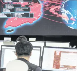  ??  ?? Employees watch an electronic board to monitor possible ransomware cyberattac­ks at the Korea Internet and Security Agency in Seoul, South Korea.