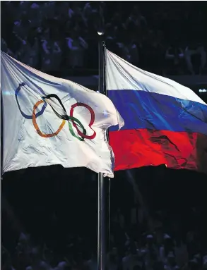  ?? CLIVE MASON / GETTY IMAGES FILES ?? The Olympic and Russian flags at Sochi in 2014. Removing Russia from Pyeongchan­g makes the South Korean Winter Games much smaller, Scott Stinson writes.