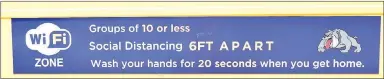  ?? Westside Eagle Observer/MIKE ECKELS ?? A sign attached to the side of a Decatur School District bus marks a WiFi zone to provide internet access to families that do not have the service. The sign also reminds students of the rules while using this service during the covid-19 outbreak.