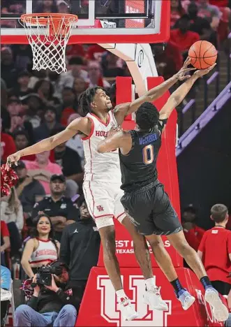  ?? Bob Levey / Getty Images ?? Memphis’ Elijah Mccadden has his shot blocked by Houston’s Tramon Mark during the No. 2-ranked Cougars’ 72-64 victory over the Tigers in Houston on Sunday.