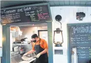  ?? RJ Sangosti, The Denver Post ?? Jesse Nine works on a to-go breakfast order at The Happy Endings Caboose Cafe at Royal Gorge Route Railroad on Monday in Cañon City.