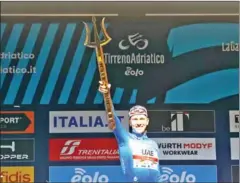  ?? AFP ?? Team UAE Emirates’ Tadej Pogacar of Slovenia celebrates on the podium with the race’s Sea Master Trophy after winning the Tirreno Adriatico cycling race on Sunday.