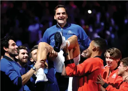  ?? ?? Team Europe and Team World hold Roger Federer aloft after his final match in London