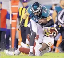  ?? MATT ROURKE/ASSOCIATED PRESS ?? Philadelph­ia tight end Zach Ertz (86) is brought down by Washington’s Zach Brown during the Eagles’ win over the Redskins Monday.