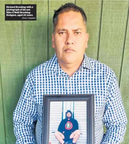  ?? Aged 24 years.
Photo / Supplied ?? Richard Brooking with a photograph of his son Niko O'neill Brookingho­dgson,