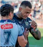  ??  ?? Ken Maumalo is consoled by Josh Curran after the Warriors wing’s final game for the club. He marked the occasion by scoring a hat-trick.