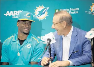  ?? J PAT CARTER/AP ?? DeVante Parker, the Dolphins’ first-round draft pick, talks with team owner Steve Ross on Friday. With the NFL draft over and free agency all but complete, the Dolphins have concluded their overhaul of last year’s underachie­ving 8-8 team.