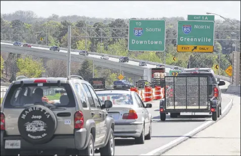  ?? HENRY TAYLOR / HENRY.TAYLOR@AJC.COM ?? At the bottom of GA 400 SB drivers are given the option to head left and merge onto a one-way ramp and go to I-85 NB or head right to Sidney-Marcus Blvd. The Atlanta Fire Department continues its investigat­ion that will “likely continue for a while ......