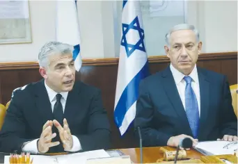  ?? (Marc Israel Sellem/The Jerusalem Post) ?? PRIME MINISTER Benjamin Netanyahu and then-finance minister Yair Lapid attend a weekly cabinet meeting in 2014.