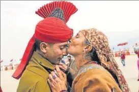  ?? WASEEM ANDRABI/HT PHOTO ?? A Kashmiri mother greets her son after his recruitmen­t as an Army soldier during a passing out parade at an army base in Srinagar on Monday.