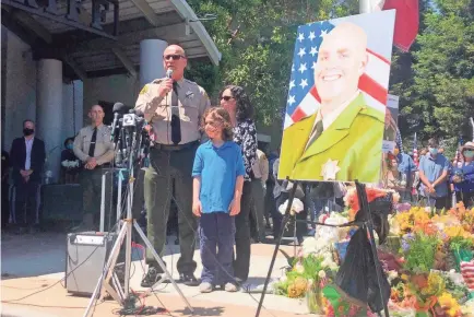  ?? MARTHA MENDOZA/AP ?? Santa Cruz Sheriff Jim Hart speaks while standing next to a photo of fallen Sgt. Damon Gutzwiller as more than a thousand people gather outside the Santa Cruz County Sheriff-Coroner’s Office to pay their respects June 7.