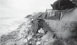  ?? JOHN RAOUX AP ?? Parts of homes collapsed on a Florida beach because of storm surge from Hurricane Nicole in Wilbur-By-The-Sea.