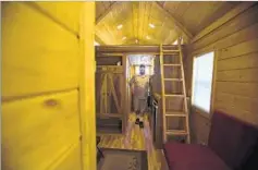  ??  ?? TINY HOMES can range from 80 to 700 square feet. But laws in many cities and counties say that single-family homes must be at least 1,000 square feet. Saenz inspects his company’s cabin-like houses.