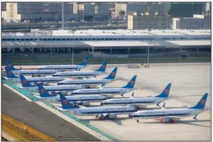  ?? (AP/Mark Schiefelbe­in) ?? China Southern Airlines Boeing 737 Max airplanes are parked at the edge of the tarmac at Urumqi Diwopu Internatio­nal Airport in Urumqi in western China’s Xinjiang Uyghur Autonomous Region in April. China’s aviation regulator cleared the Boeing 737 Max on Thursday to return to flying with technical upgrades more than two years after the plane was grounded worldwide.