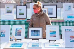  ?? Jarret Liotta / For Hearst Connecticu­t Media ?? Photograph­er Jessica Ryan, of Southport, stands by her work at the Westport Farmers Market on Tuesday.