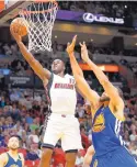  ?? WILFREDO LEE/ASSOCIATED PRESS ?? Miami’s Dion Waiters (11) goes for a layup against Golden State’s JaVale McGee during the Heat’s win over the Warriors Monday.