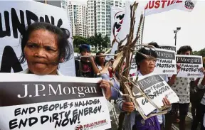  ??  ?? Clean energy: Environmen­tal activists protest in suburban Taguig city east of Manila. The activists describe coal use as one of the main contributo­rs to global warming and climate change. — AP