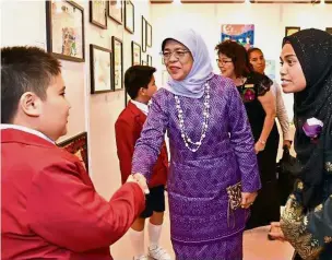  ??  ?? Halimah (in purple) at the official opening of the Associatio­n for Persons with Special Needs Chaoyang School. — The Straits Times/ Asia News Network